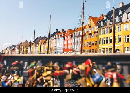 Romantic view on a summer sunny day at Nyhavn Pier with colorful beautiful buildings in the Old Town of Copenhagen, Denmark. Defocused foreground of c Stock Photo