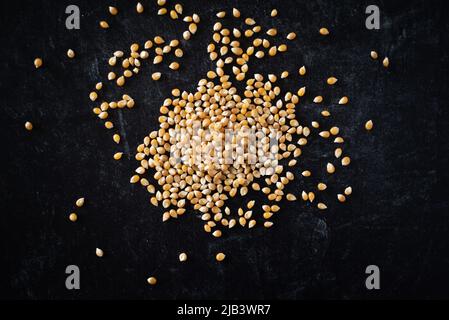 Top view of corn kernels on dark moody background. Stock Photo