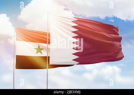 Sunny blue sky and flags of qatar and syria Stock Photo