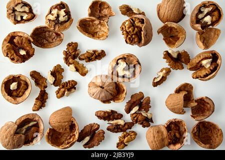 Chopped walnuts and shells on a white background. Stock Photo