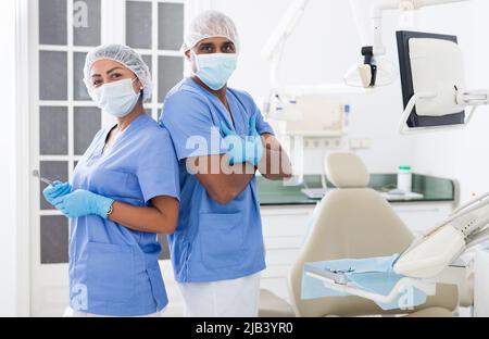Two professional dentists standing in modern dental clinic Stock Photo