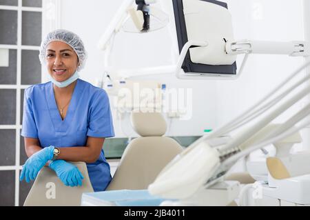 Smiling professional dentist woman posing in dental clinic Stock Photo