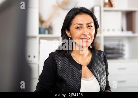 Successful latin american business woman in office interior Stock Photo