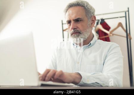 Professional European adult freelancer man focused on his work. Technology and business concept. High quality photo Stock Photo