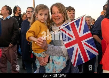 Hove Promenade, Hove Lagoon, City of Brighton & Hove, East Sussex, UK. Hove Beacon Relighting celebrating Queen Elizabeth II Platinum Jubilee celebrations. The beacon was alight with a specially designed LED display created by local artist Eleni Shiarlis. This is going to be a permanent display turned on every evening. Hundreds of local residents attended the lighting of the beacon. June 2nd 2022. David Smith/Alamy News Stock Photo