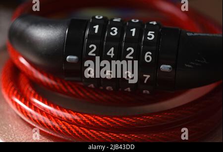 Bicycle combination lock with red plastic over wire cable Stock Photo