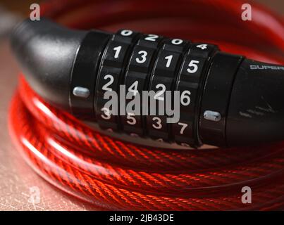 Bicycle combination lock with red plastic over wire cable Stock Photo