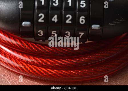 Bicycle combination lock with red plastic over wire cable Stock Photo