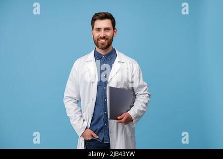 Professional Doctor In white uniform posing on camera with clipboard  Stock Photo