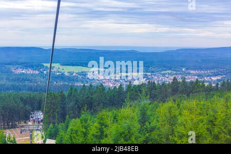 Wurmberg ride with the red gondola cable car railway with panorama view to mountain landscape of Braunlage Harz Goslar in Lower Saxony Germany.