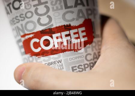 Hand-held coffee cup Stock Photo