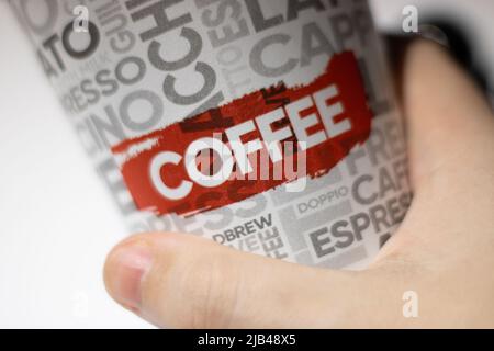 Hand-held coffee cup Stock Photo