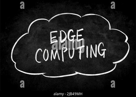 Close up phrase Edge Computing by handwriting white coloured chalk on blackboard. The surface of blackboard is powdery and rough. Stock Photo