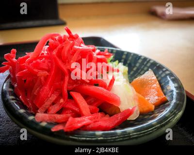 Beni Shoga, Japanese traditional side dish thin strips of ginger pickled in umezu on a small plate. Red color is derived from red perilla Stock Photo