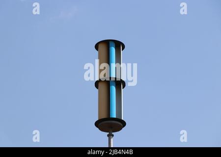 Vertical axis wind turbine or VAWT with blue sky in the background Stock Photo