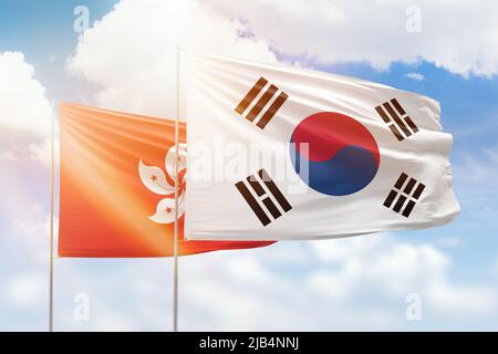 Sunny blue sky and flags of south korea and hong kong Stock Photo