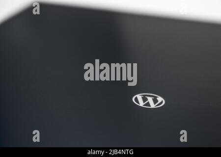 WordPress logo on tablet in monochrome. WP is using content management system (CMS) based on PHP, MySQL. Used by over 60 million websites Stock Photo
