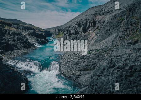 Aerial drone panorama of studlagil canyon in Iceland, picturesque valley with basalt columns standing high on a warm summer day. Closeup of the basalt Stock Photo