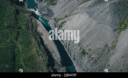Aerial drone panorama of studlagil canyon in Iceland, picturesque valley with basalt columns standing high on a warm summer day. Overview of the valle Stock Photo