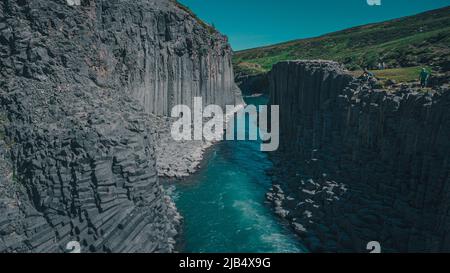 Aerial drone panorama of studlagil canyon in Iceland, picturesque valley with basalt columns standing high on a warm summer day. Stock Photo