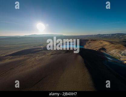 Aerial drone view of Viti crater in Krafla area of Iceland viewed from one of the outlook posts, on a nice summer evening, with sun slowly setting dow Stock Photo