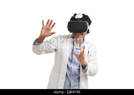 Young peruvian male scientific using virtual reality headset, isolated. Stock Photo