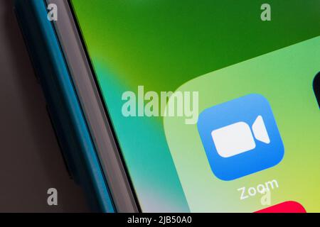 Zoom, videotelephony & online chat services app, on iPhone. Zoom Video Communications, Inc. is an US technology company based in San Jose, CA Stock Photo