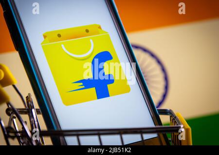 Flipkart, an e-commerce company based in Bangalore, Karnataka, India, on iPhone in cart with Indian flag. Flipkart is No 1 online retailer in India Stock Photo