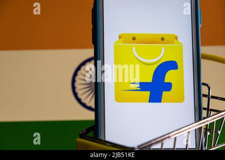 Flipkart, an e-commerce company based in Bangalore, Karnataka, India, on iPhone in cart with Indian flag. Flipkart is No 1 online retailer in India Stock Photo