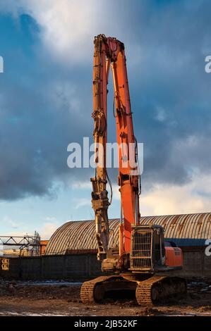 Special excavator destroyer with scissors at demolition site Stock Photo