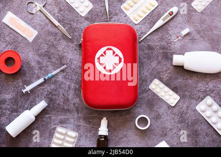 Home first aid kit, pills, thermometer on plain background Stock Photo