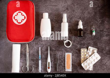 Home first aid kit, pills, thermometer on plain background Stock Photo
