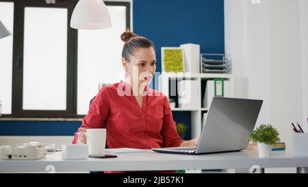 Executive manager taking notes on financial documents to create data charts with sales statistics. Accountant analyzing research papers and report on laptop for business development. Stock Photo