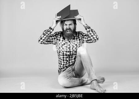 overworked guy. paper work concept. typical office life. bearded man working with project. bearded student making notes in his paper. casual styled Stock Photo