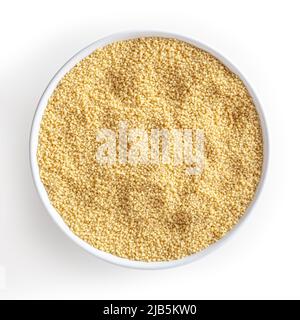 Uncooked couscous in white bowl isolated on white background with clipping path Stock Photo