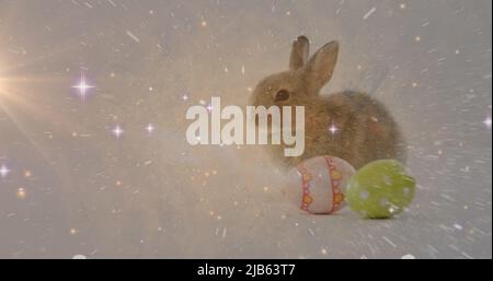 Composite image of space against easter bunny and decorative easter eggs in background Stock Photo