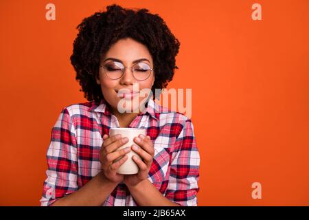 Portrait of positive lady enjoy hot latte cacao smell wear plaid clothes isolated vibrant color background Stock Photo