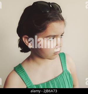 Small girl posing, facial expression. Stock Photo