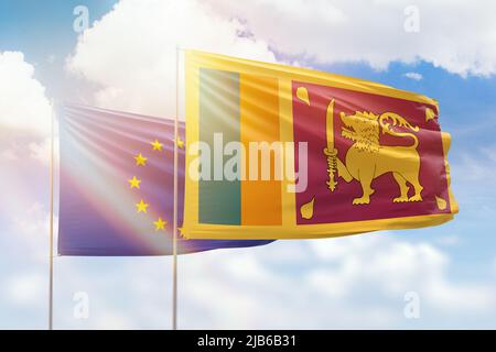 Sunny blue sky and flags of sri lanka and european union Stock Photo