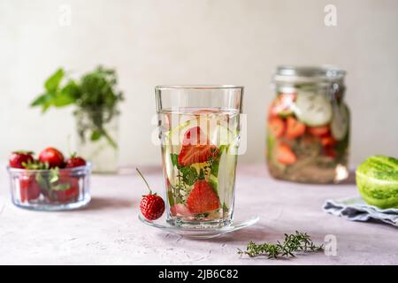 Infused water with strawberry and meloncella that is hybrid of cucumber and melon, thyme, mint.  Stock Photo