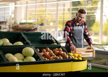 Young Single Man Showing Fruit and Vegetables at Shopping in