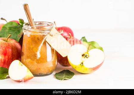 Apple jam with fresh apples on white background. Stock Photo
