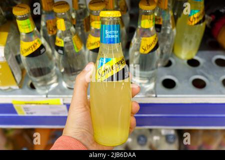 Tyumen, Russia-May 11, 2022: Popular Schweppes products ginger ale, introduced in 1870. Buying in a hypermarket Stock Photo
