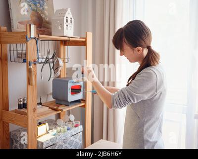 Lifestyle concept, work from home to reinvent your life - Jewelry designer workplace. Woman make jewelry. Georgian minankari enamel manufacturing tech Stock Photo