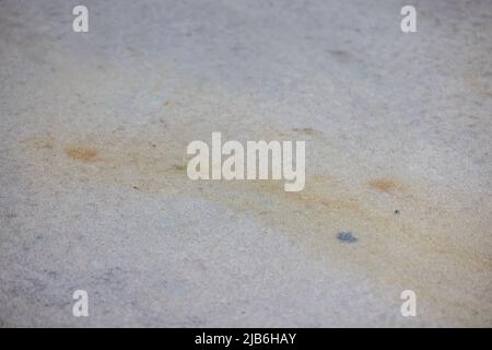 Dirty rust and dirt stains on a concrete driveway or sidewalk that need to be pressure washed Stock Photo