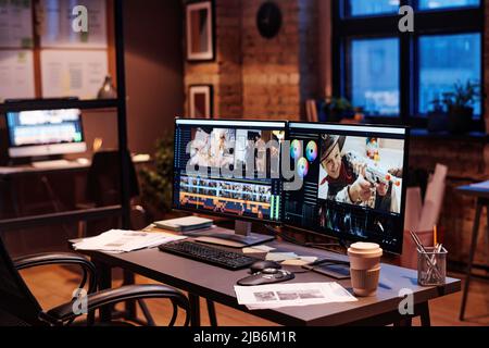 Image of workplace of colorist with computer monitors and documents on table at modern office Stock Photo