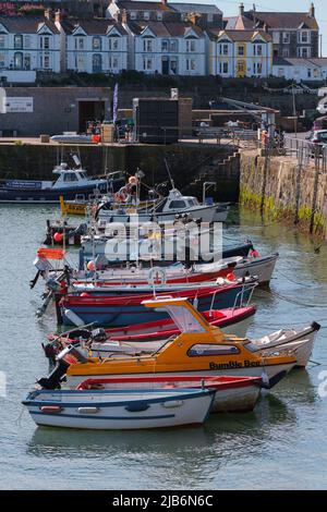 Fishing boats and other small craft in the Cornish fishing harbour of Porthleven Stock Photo