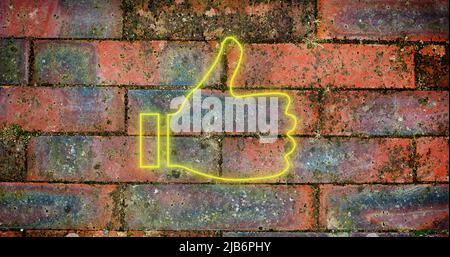 Image of glowing neon thumb up icon on brick wall Stock Photo