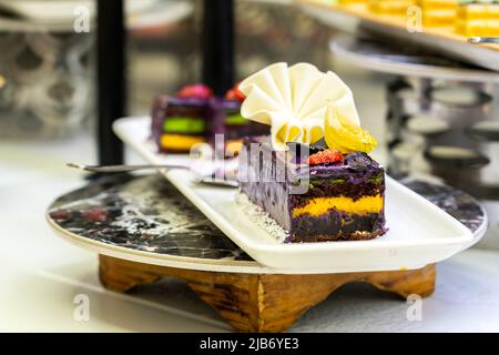 Chocolate cakes on a plate in a hotel minibar Stock Photo