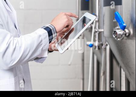 Work in modern brewery, data collection and production monitoring. High quality photography. Stock Photo
